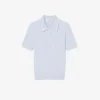 Maglione a righe con collo a polo e lavorazione a trecce Maglione a righe con collo a polo e lavorazione a trecce
