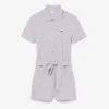 Tuta con colletto polo in piqué elasticizzato Tuta con colletto polo in piqué elasticizzato
